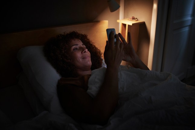 Woman using smart phone at home
