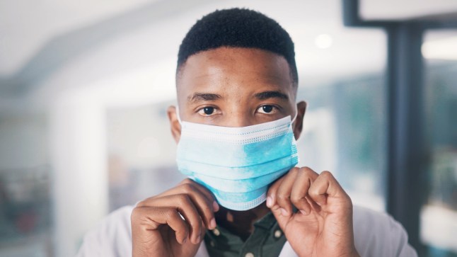 Portrait, doctor or black man in hospital with face mask for healthcare policy or protection from infection. Medical professional, person or PPE for safety compliance, wellness and spread of disease.