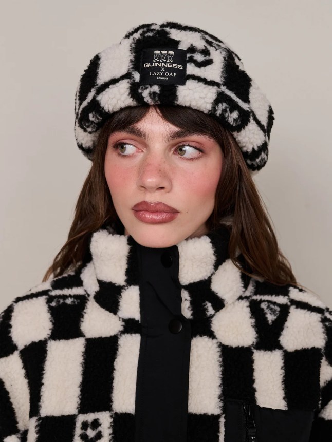 Female wears black and white fleece hat and matching zip jacket