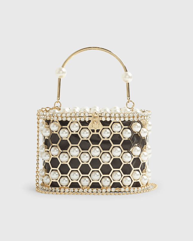 Black and gold top handle bag with large pearl detail