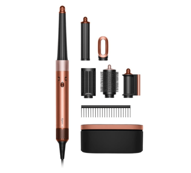 Gold-handled hair tool from Dyson with accessories