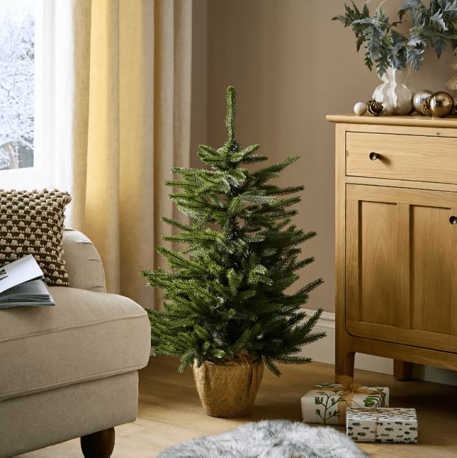 Small christmas tree in the corner of a livingroom
