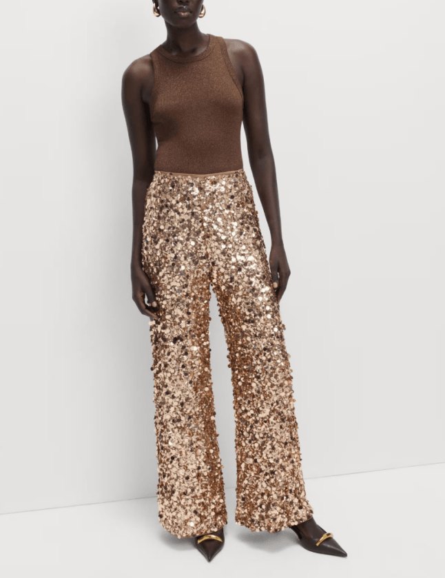 Female wears gold sparkly trousers