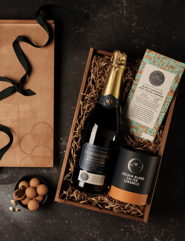 Bottle of sparking wine and small box of chocolates