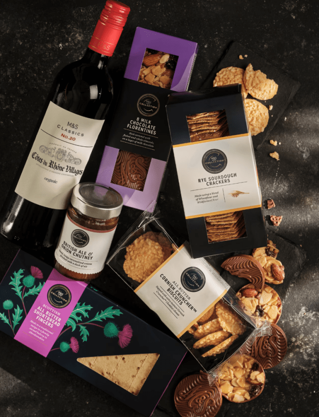 Red wine, chutney, crackers and crisps on dark background