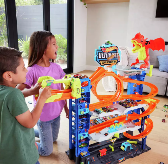 Children playing with brightly coloured track for cars