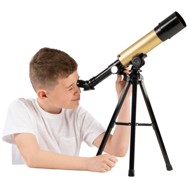 Young boy looking through a telescope