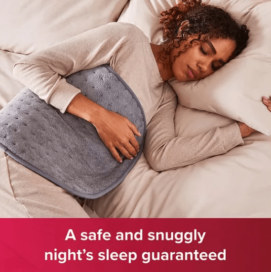 Female holds grey heated pag against her body