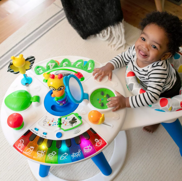 Child sat inside colourful toy for exploring