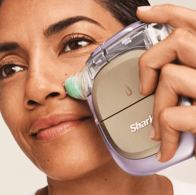 Female uses skincare device on her nose