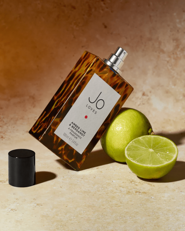 Bottle of fragrance resting on lime