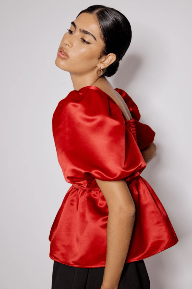 Female wears red satin top