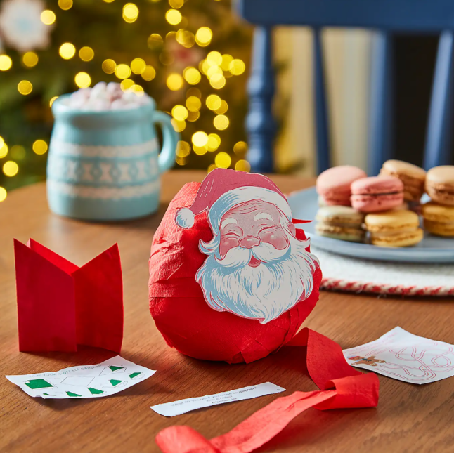 Face of Father Christmas stuck on small red ball