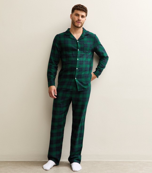 Male wears green checked shirt and dark jeans