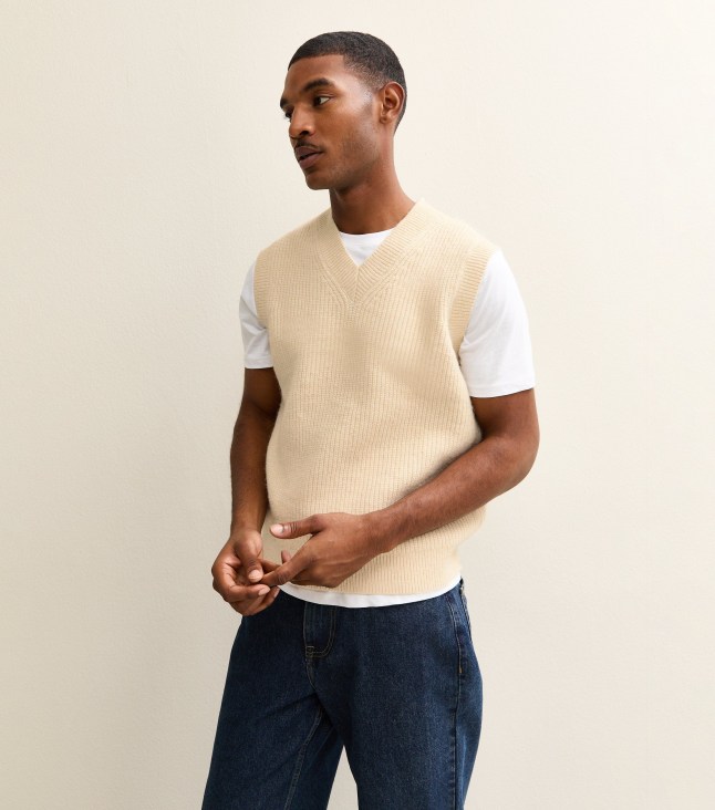 Male wears pale vest with white t-shirt