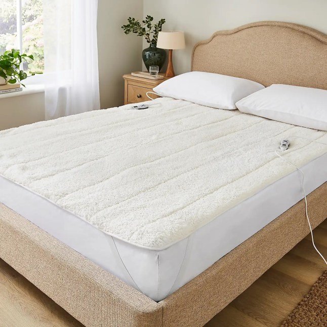 Bed with heated blanket on top