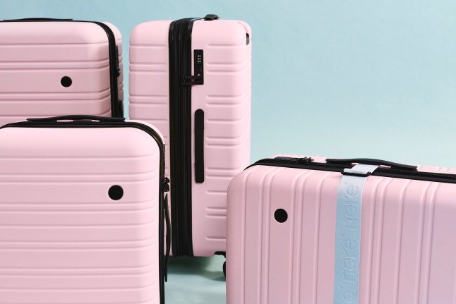 Stack of four pink suitcases