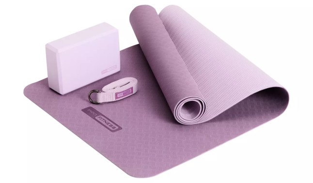 Purple yoga mat with yoga equipment