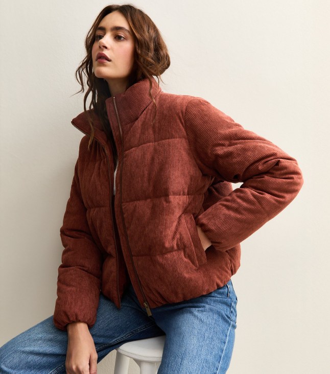 Female wears rust-coloured cropped puffa jacket