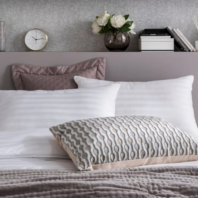 White striped pillows on a made bed