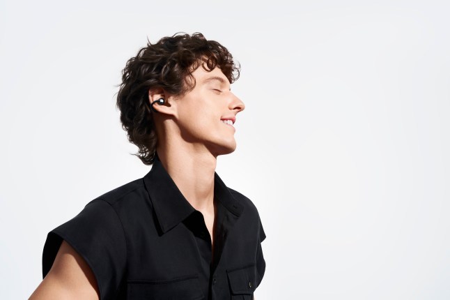 Male wears Huawei FreeClip 2 earphones