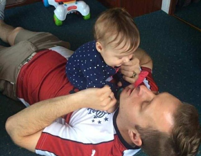 Robert on the ground with a months-old Stella-Lily on top