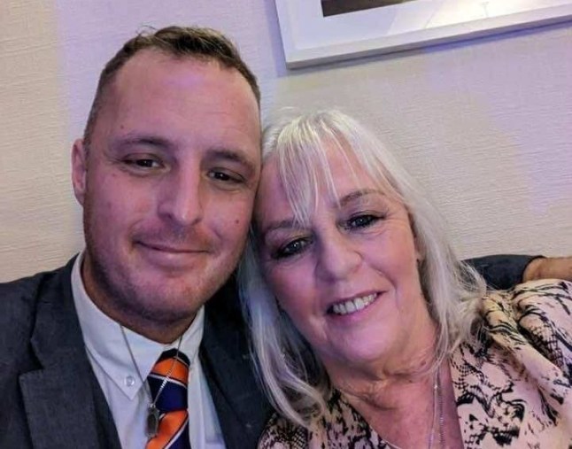 Robert, dressed in a shirt and tie, and Lorraine in a patterned blouse, taking a selfie