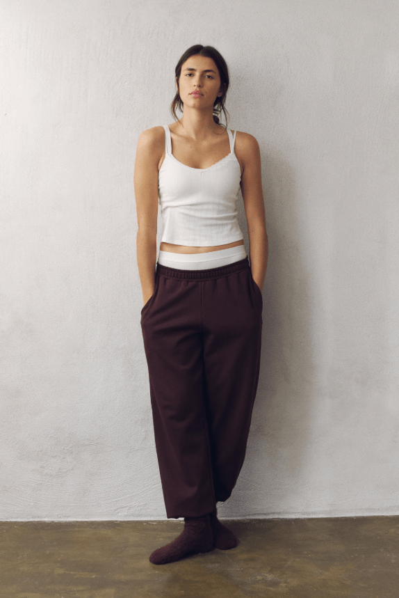 Female wears joggers and white vest top