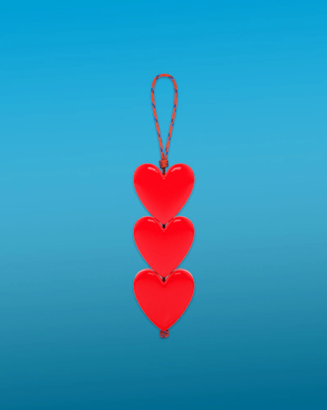 Three hearts on a red cord