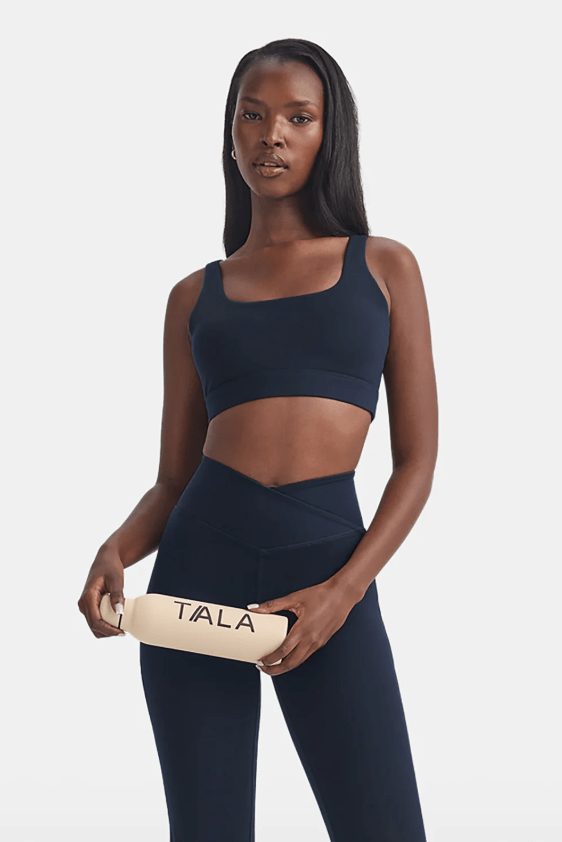 Female wears black sports bra and leggings