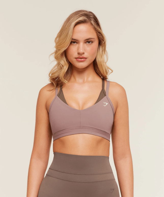 Female wears pinky/nude sports bra
