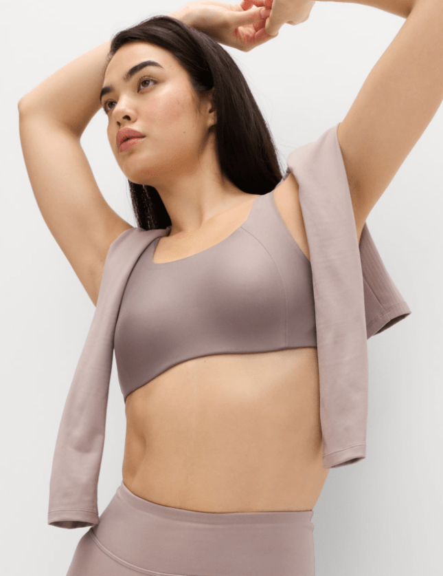 Female wears beige sports bra