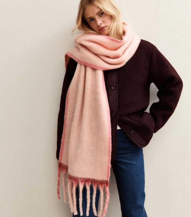 Female wears large pink scarf