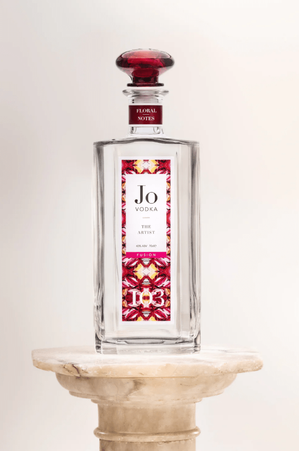 Bottle of clear liquid with floral label