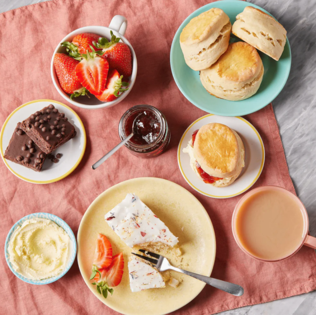 Afternoon tea items including fruit, scones and cream