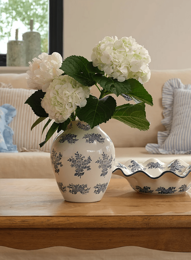 Blue and white floral vase with white flowers inside