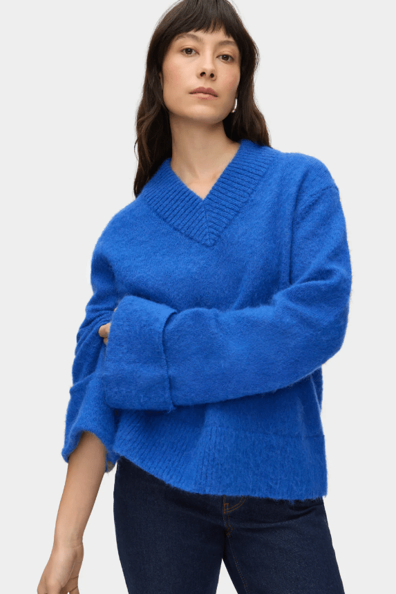 Female wears blue, v-neck sweater
