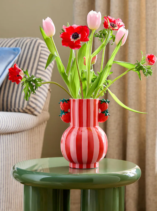 Flowers in a pink and red stripe vase