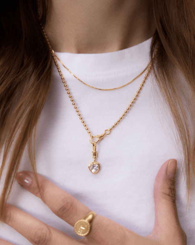 Female wears white tshirt and gold necklace