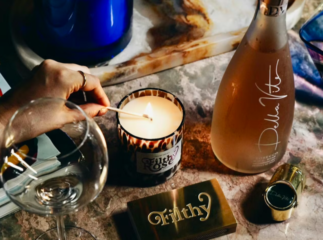 Candle being lit and a bottle of alcohol