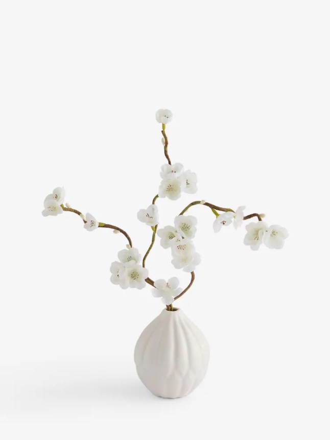 White faux blossom plant in pot