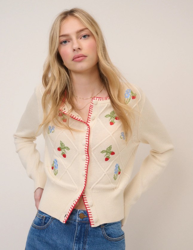 Female wears cardigan with strawberry stitching