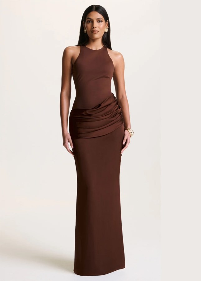 Female wears high neck, tight fitting dress in brown