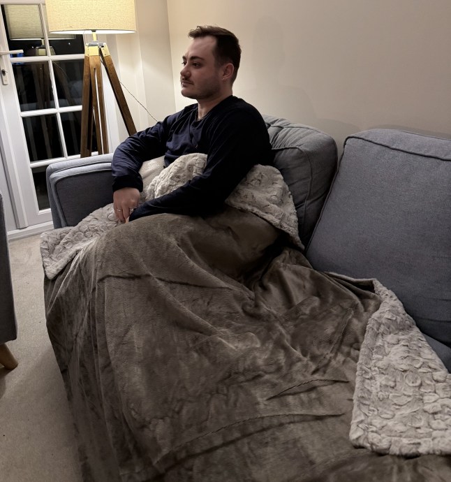 Scott lounging on the sofa with the Dunelm blanket