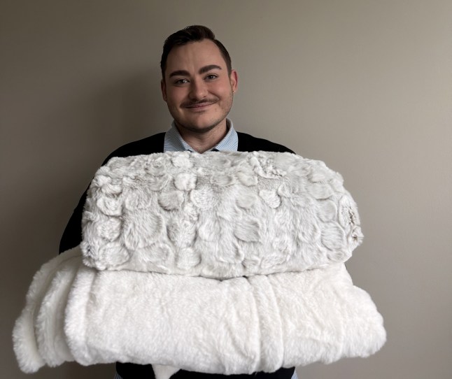 Scott holding both the Dunelm heated blanket and the Carmen heated blanket