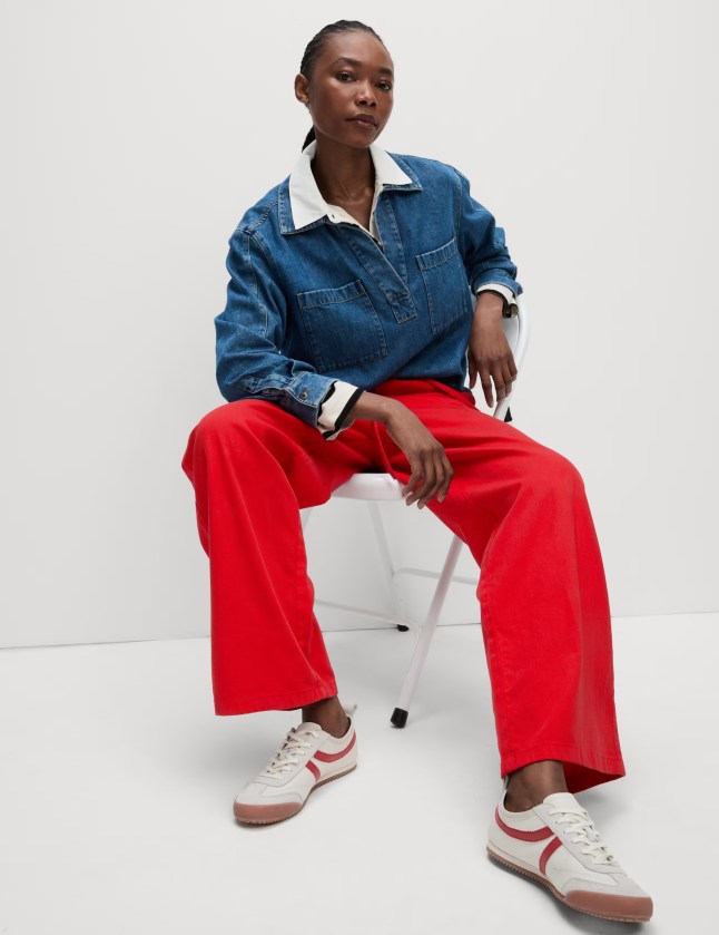 Female wears brightly coloured trousers and top