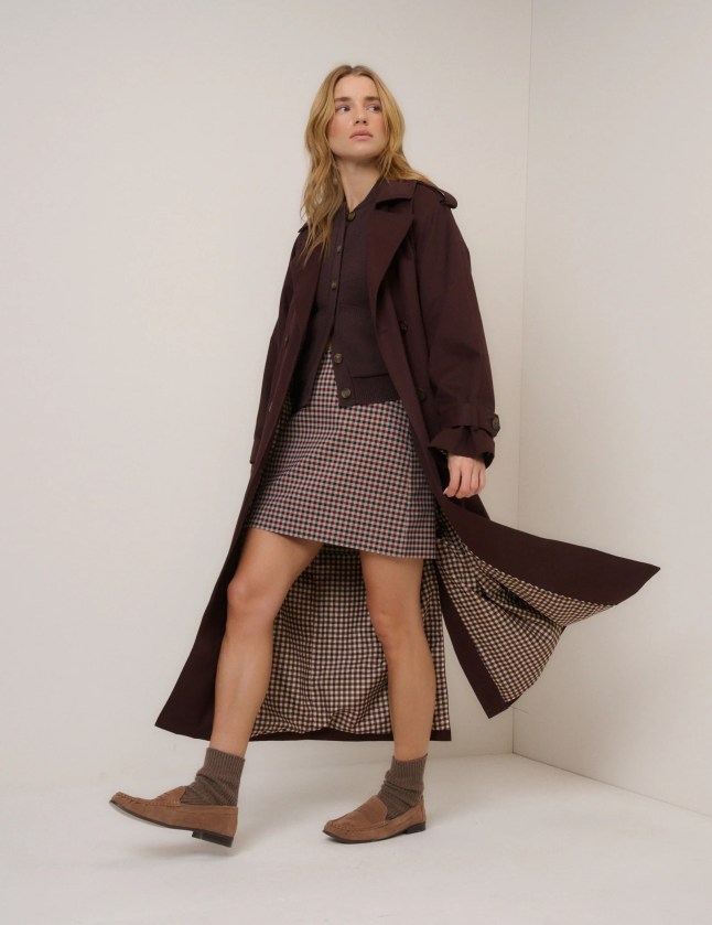 Female wears trench coat and dress with boots