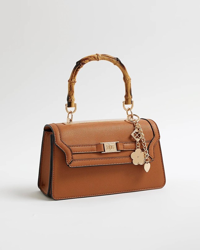 Brown bag with small top handle and bag charm