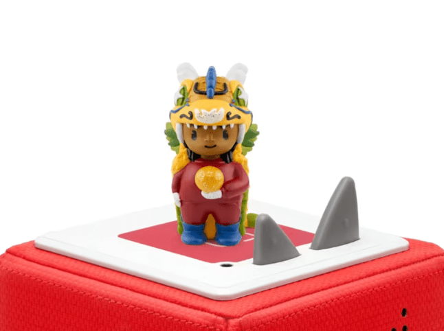 Small toy figure ontop of electrical device