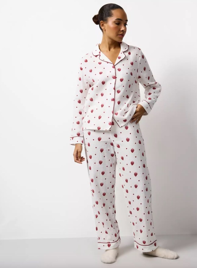 Female wears white pjs with small printed strawberry on